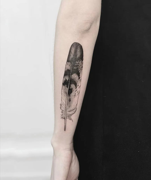Medium Black and Grey Feather Tattoo on Women Arm by @sliwka.tattoo