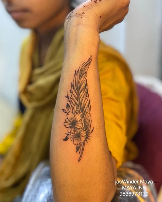 Medium Black and Grey Feather and Flower Tattoo on Women Forearm by @jaswindermaya