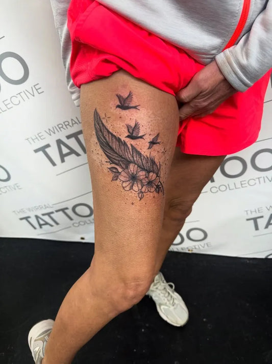 Medium Black and Grey Feather and Flowers Tattoo on Women Thigh by @leah_nicole23x