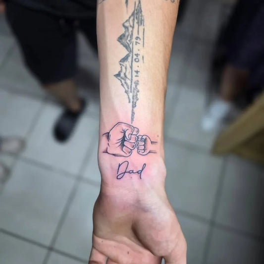 Medium Black and Grey Fist Bump with Mountains and Dad Text Family Tattoo on Men Forearm by @lrt_art_