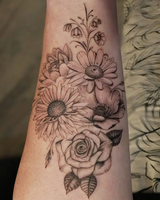 Medium Black and Grey Floral Bouquet with Daisy and Rose Tattoo on Women Arm by @rudrainktattoo