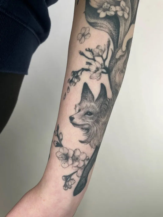 Medium Black and Grey Fox and Cherry Blossom Tattoo on Women Arm by @laurencoley_tattoo