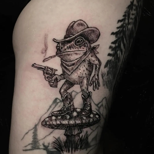 Medium Black and Grey Frog Cowboy with Mushroom Tattoo on Men Thigh by @thetylermorristattoo