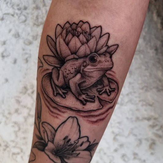 Medium Black and Grey Frog and Lotus Tattoo on Women Arm by @kenny7tattoo