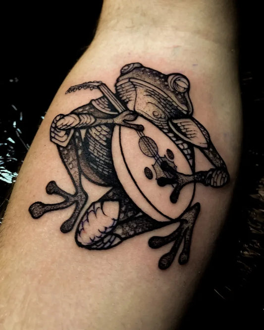 Medium Black and Grey Frog with Drum Tattoo on Men Arm by @madrededios_