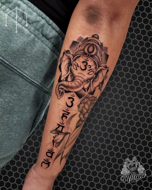 Medium Black and Grey Ganesha with Om and Lotus Spiritual Tattoo on Men Arm by @milanihoney