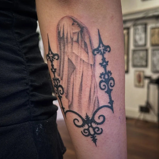 Medium Black and Grey Ghost with Ornate Frame Tattoo on Women Arm by @breelintattoo