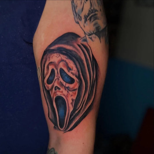 Medium Black and Grey Ghostface Mask Horror Tattoo on Men Arm by @thrillvulturetattoo