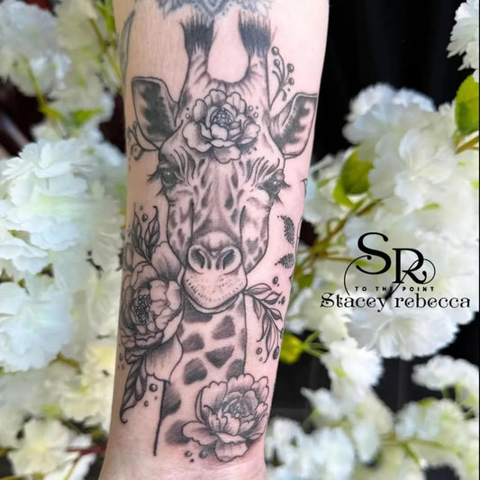 Medium Black and Grey Giraffe and Roses Animal Tattoo on Women Arm by @tothepoint_23