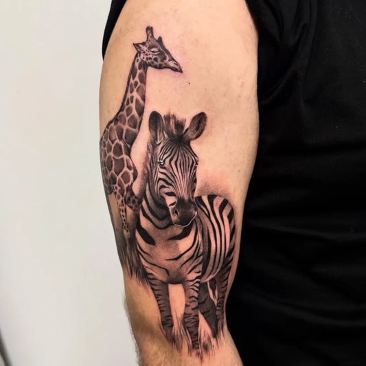 Medium Black and Grey Giraffe and Zebra Animal Tattoo on Men Arm by @maddyltattoo