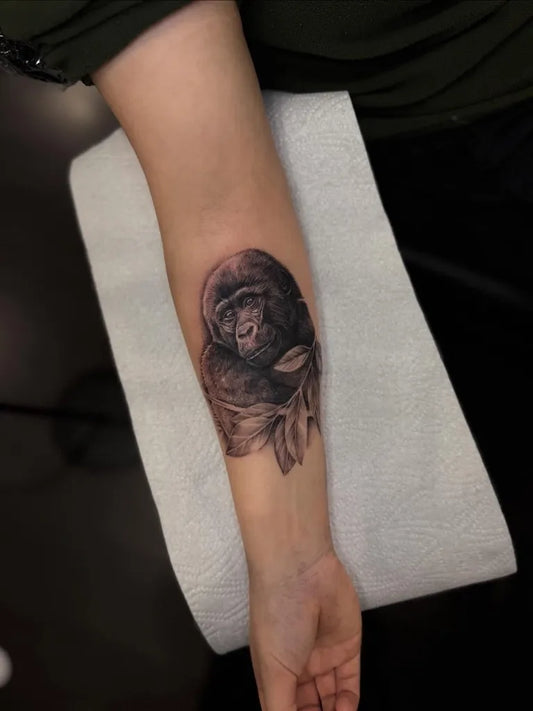 Medium Black and Grey Gorilla with Leaves Tattoo on Women Arm by @tattoosbykase