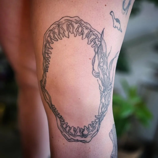 Medium Black and Grey Great White Shark Jaw and Dinos on Women Thigh Tattoo by @kelleytheartist