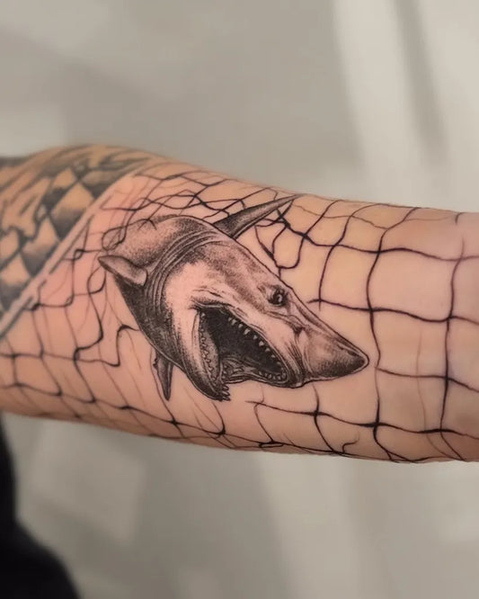 Medium Black and Grey Great White Shark in Net on Men Arm Tattoo by @ramazanserttas_tattoo