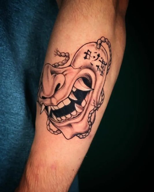 Medium Black and Grey Half Oni Mask with Cord on Men Arm Tattoo by @tattooxenia