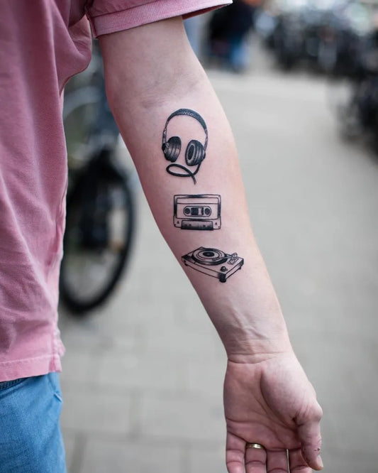 Medium Black and Grey Headphones Cassette Turntable Music Tattoo on Men Arm by @annedekkertattoo