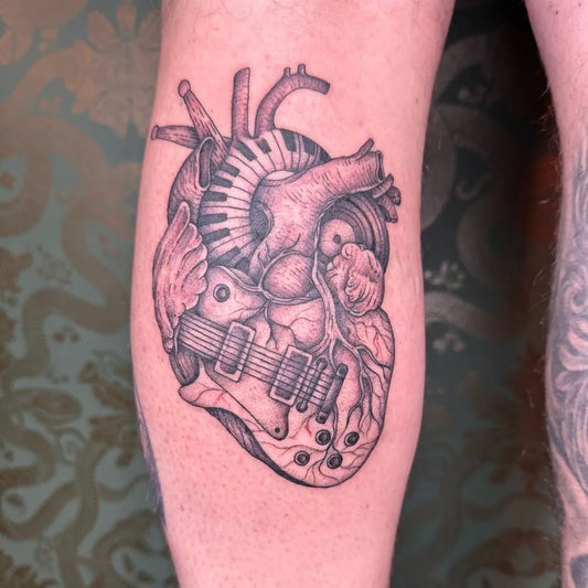 Medium Black and Grey Heart with Guitar and Piano Men Leg Tattoo on by @cal_tattooist_