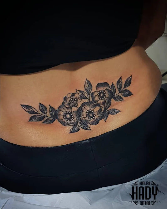 Medium Black and Grey Hibiscus Flowers Tattoo on Women Lower Back by @hadytattoo