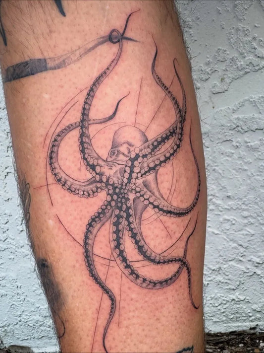 Medium Black and Grey Hooked Octopus Tattoo on Men Leg by @9ninetattoos