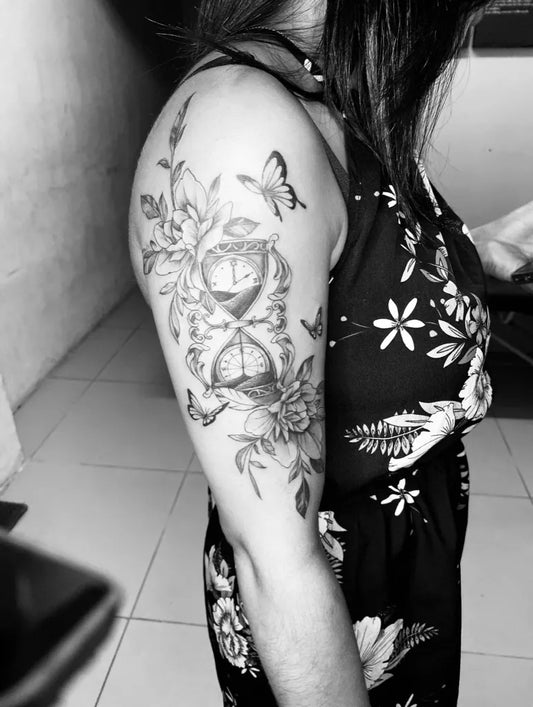 Medium Black and Grey Hourglass Flowers and Butterflies Tattoo on Women Arm by @iceinkcpt