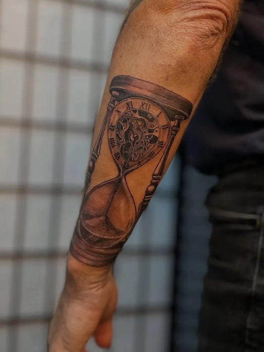 Medium Black and Grey Hourglass Tattoo on Men Forearm by @rubeered.ink