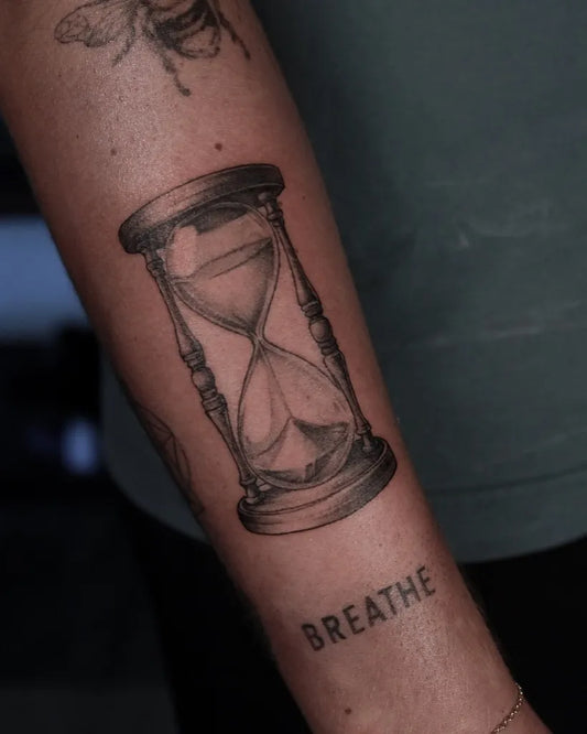 Medium Black and Grey Hourglass and Bee Tattoo on Women Arm by @descriptive_art_collective