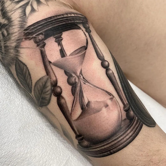 Medium Black and Grey Hourglass and Floral Tattoo on Men Arm by @tattoosnob