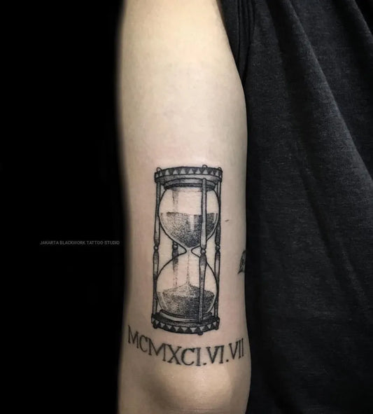 Medium Black and Grey Hourglass and Roman Numerals Tattoo on Men Arm by @jakartablackwork