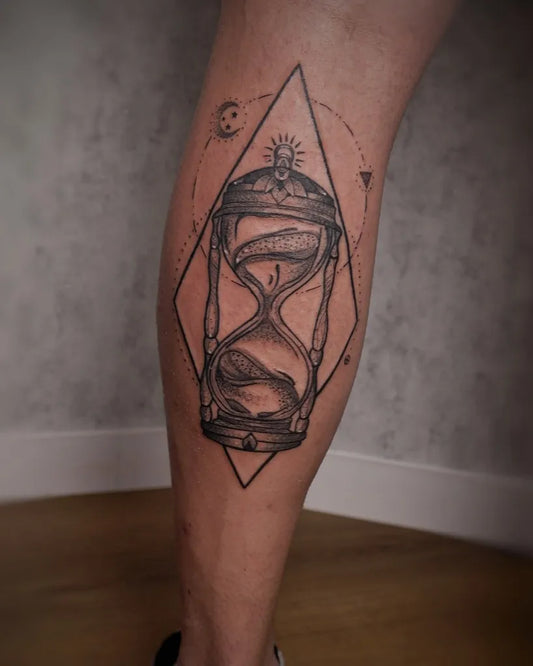 Medium Black and Grey Hourglass with Celestial Symbols Tattoo on Men Leg by @paulo_borrega