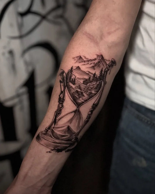 Medium Black and Grey Hourglass with Mountains Tattoo on Men Arm by @michele_mike_mazzacane