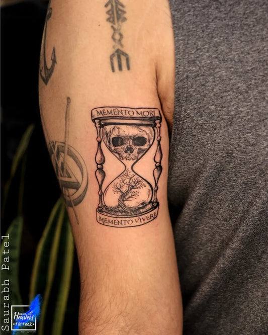 Medium Black and Grey Hourglass with Skull Tattoo on Men Arm by @blue_heaven_tattooz