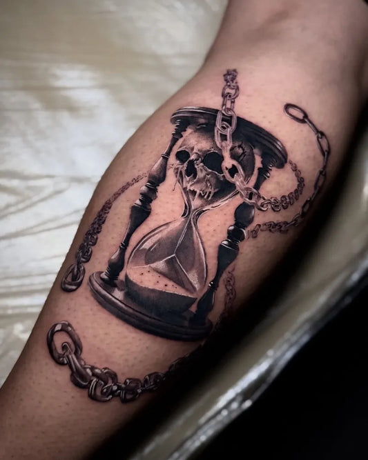 Medium Black and Grey Hourglass with Skull and Chains Tattoo on Men Arm by @hesper_tattoo