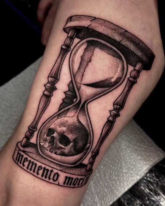 Medium Black and Grey Hourglass with Skull and Memento Mori Tattoo on Men Arm by @hadesgravetattoos