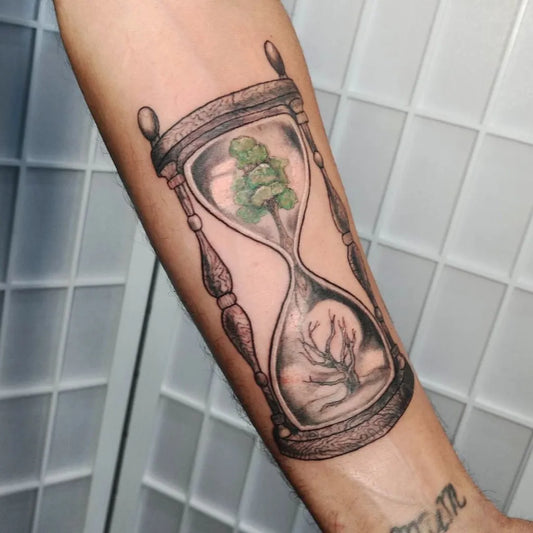 Medium Black and Grey Hourglass with Trees Tattoo on Men Arm by @kingsofink_