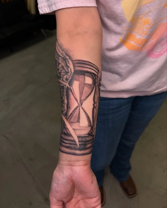 Medium Black and Grey Hourglass with Wings Tattoo on Women Arm by @kianahopetattoo