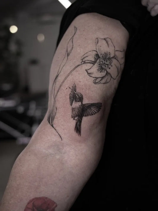 Medium Black and Grey Hummingbird and Flower on Women Arm Tattoo by @the_devlintattoos