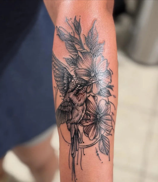 Medium Black and Grey Hummingbird and Flowers on Women Arm Tattoo by @ayons_finest_ink