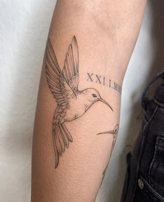 Medium Black and Grey Hummingbirds and Roman Numerals on Women on Arm Tattoo by @sarahnouva