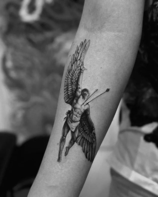 Medium Black and Grey Icarus with Wings and Bow on Women Arm Tattoo by @gangahart
