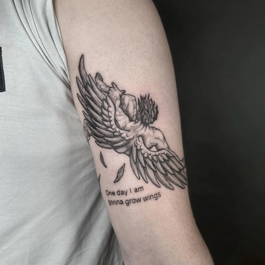 Medium Black and Grey Icarus with Wings and Quote on Men Arm Tattoo by @deadvenomtattoo
