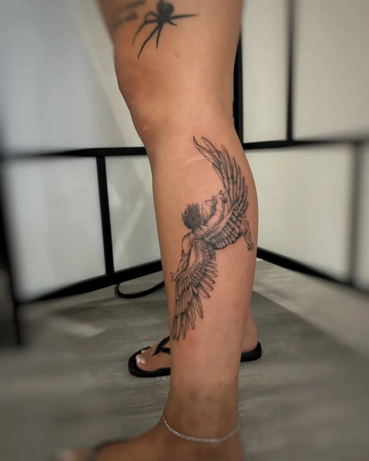 Medium Black and Grey Icarus with Wings on Women Leg Tattoo by @egarringertattoo
