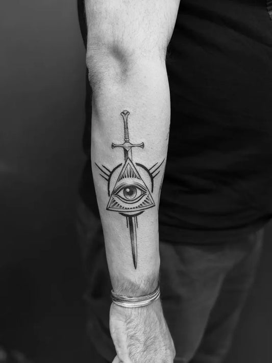 Medium Black and Grey Illuminati Eye Sword Wings on Men Arm Tattoo by @skinmachinetattoo
