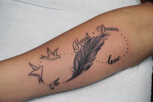 Medium Black and Grey Infinity Feather Birds Tattoo on Women Arm by @thegrasshopperstudio