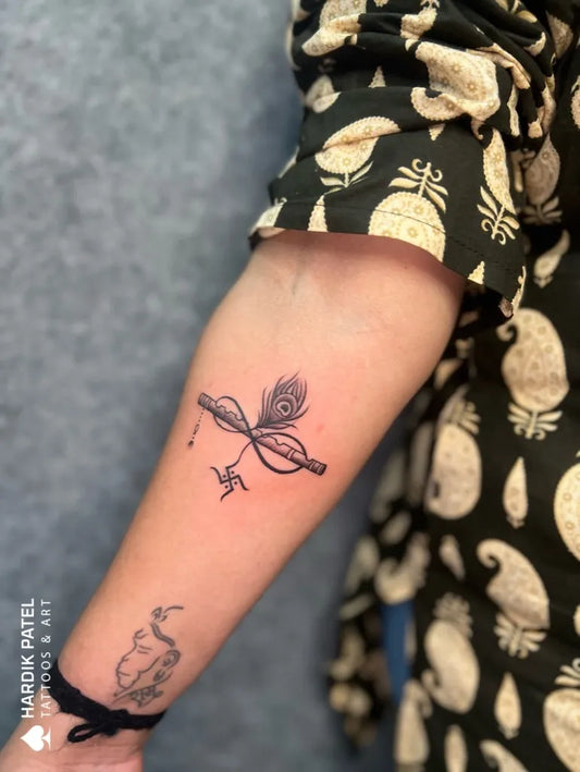 Medium Black and Grey Infinity Symbol with Peacock Feather Tattoo on Women Forearm by @hardikpatelofficial007
