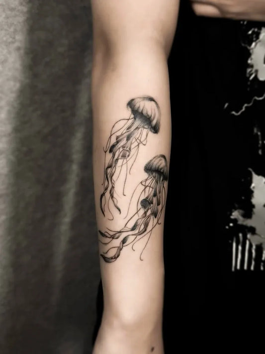 Medium Black and Grey Jellyfish Tattoo on Women Arm by @hazetattooist