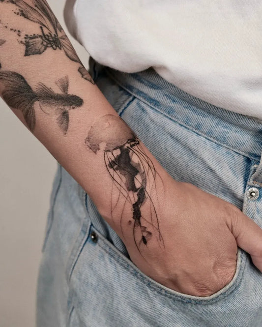 Medium Black and Grey Jellyfish and Koi Tattoo on Women Arm by @wilwang_tatt