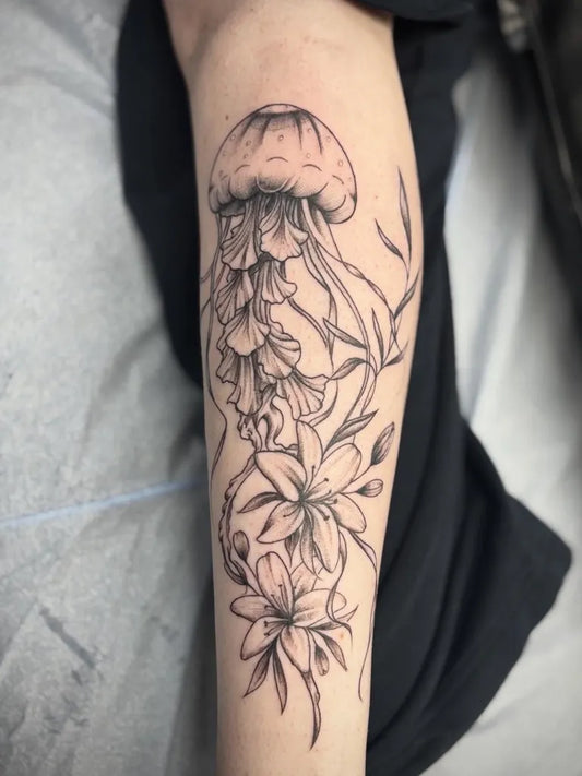 Medium Black and Grey Jellyfish and Lilies Tattoo on Women Arm by @bodylanguagetattoo_ohio