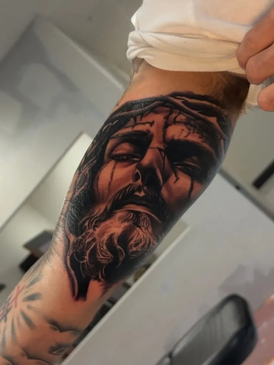 Medium Black and Grey Jesus Portrait Tattoo on Men Arm by @whotattedthat916