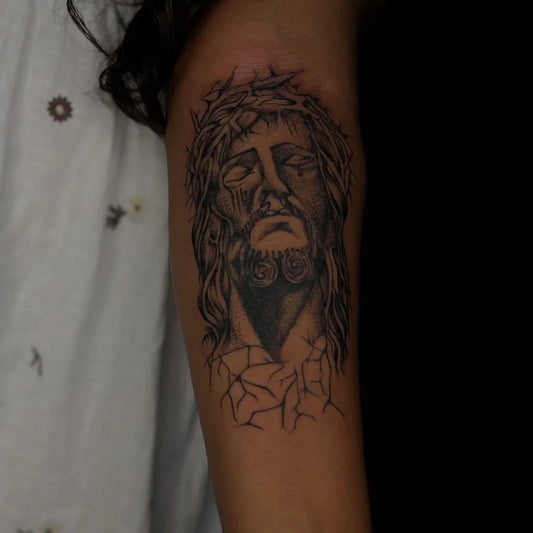 Medium Black and Grey Jesus with Crown of Thorns Tattoo on Women Arm by @poppus__tattoo