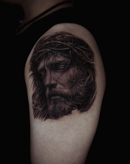 Medium Black and Grey Jesus with Crown of Thorns Tattoo on Women Shoulder by @haak_tattoo