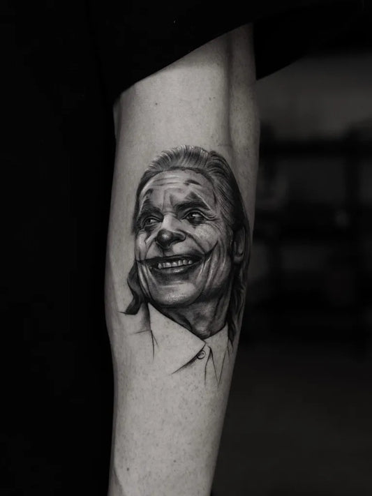 Medium Black and Grey Joker Portrait on Men Arm Tattoo by @t.a.e_t